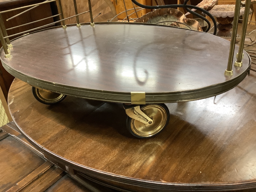 A brass mounted simulated rosewood oval two tier tea trolley, c.1970, width 70cm depth 45cm height 68cm